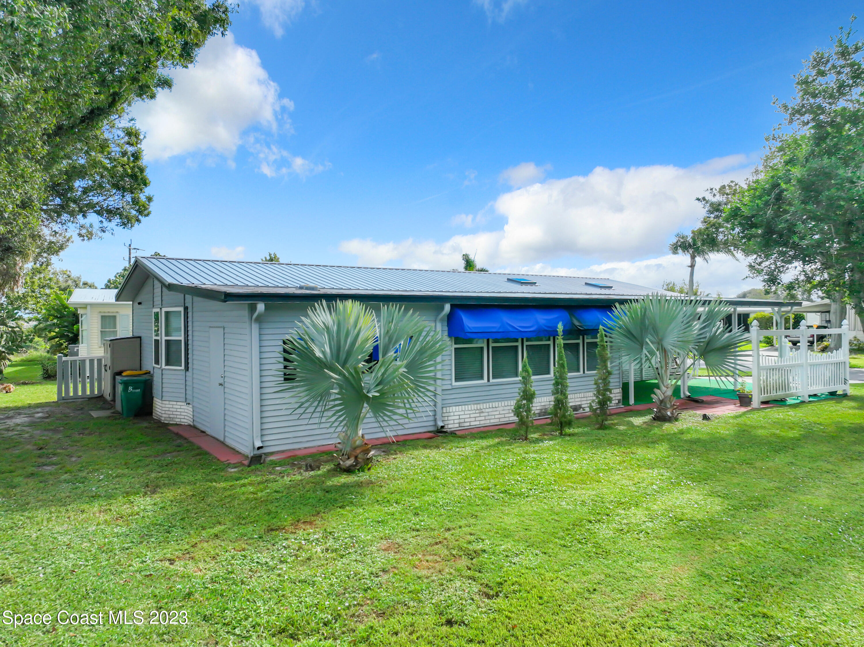 832 Periwinkle Circle Sebastian, FL 32976 - Photo 43 of 52 a view of a house with a yard and sitting area