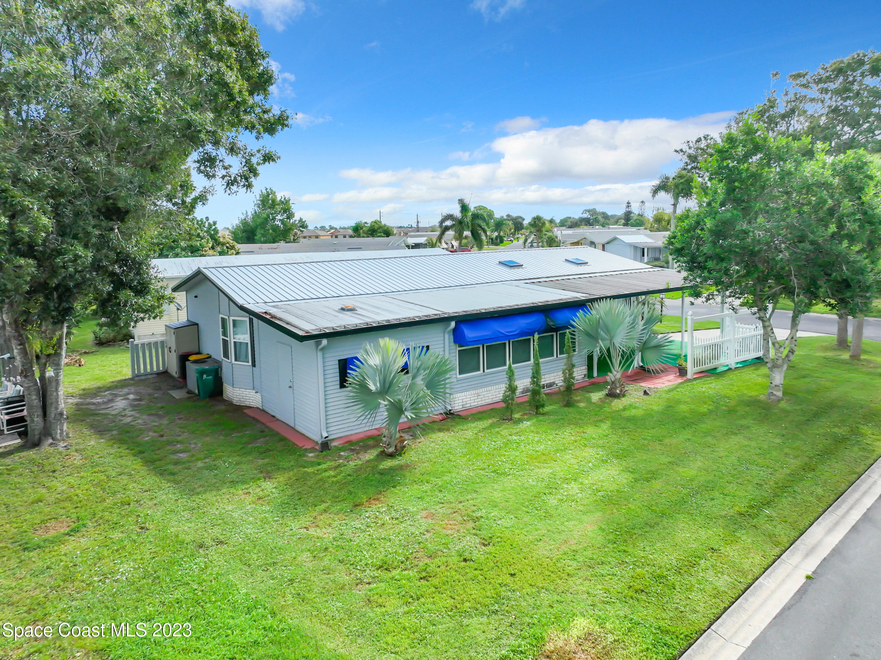 832 Periwinkle Circle Sebastian, FL 32976 - Photo 45 of 52 a view of a house with a big yard and large trees