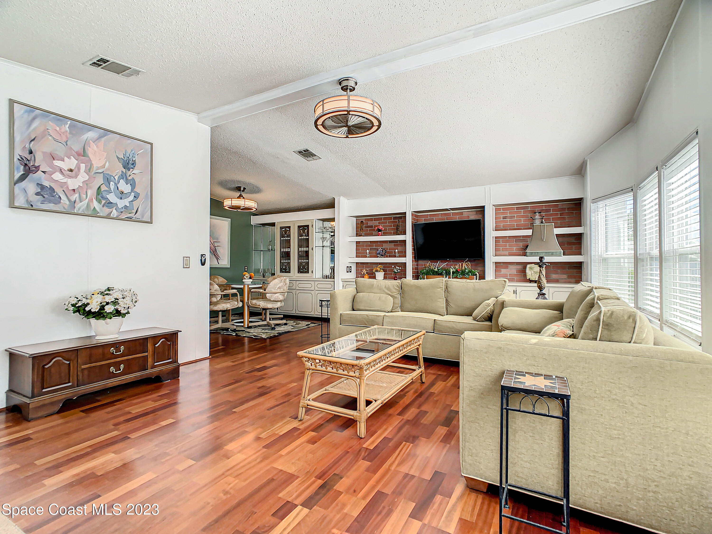 832 Periwinkle Circle Sebastian, FL 32976 - Photo 8 of 52 a living room with furniture and a flat screen tv