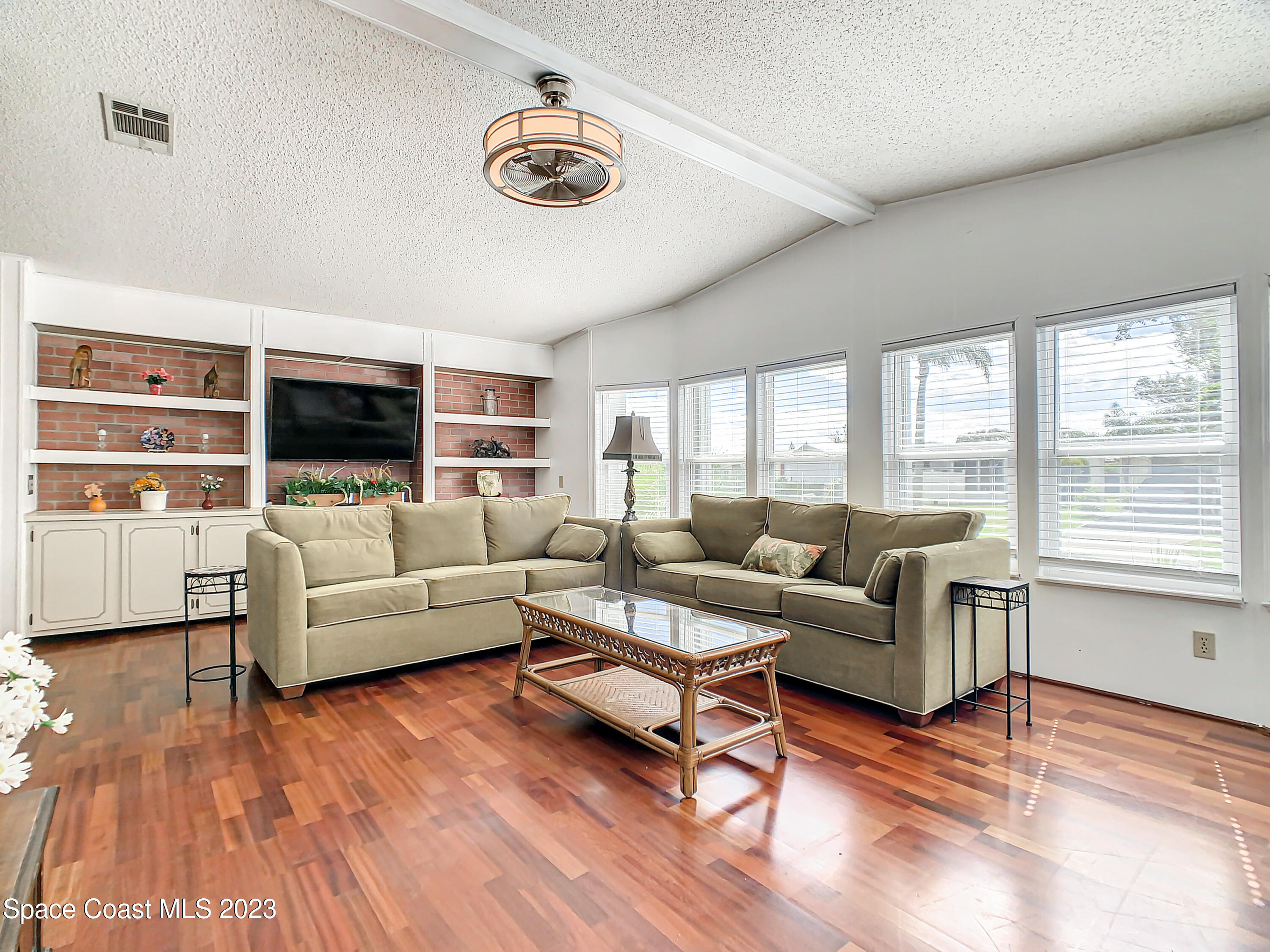 832 Periwinkle Circle Sebastian, FL 32976 - Photo 9 of 52 a living room with furniture and a flat screen tv