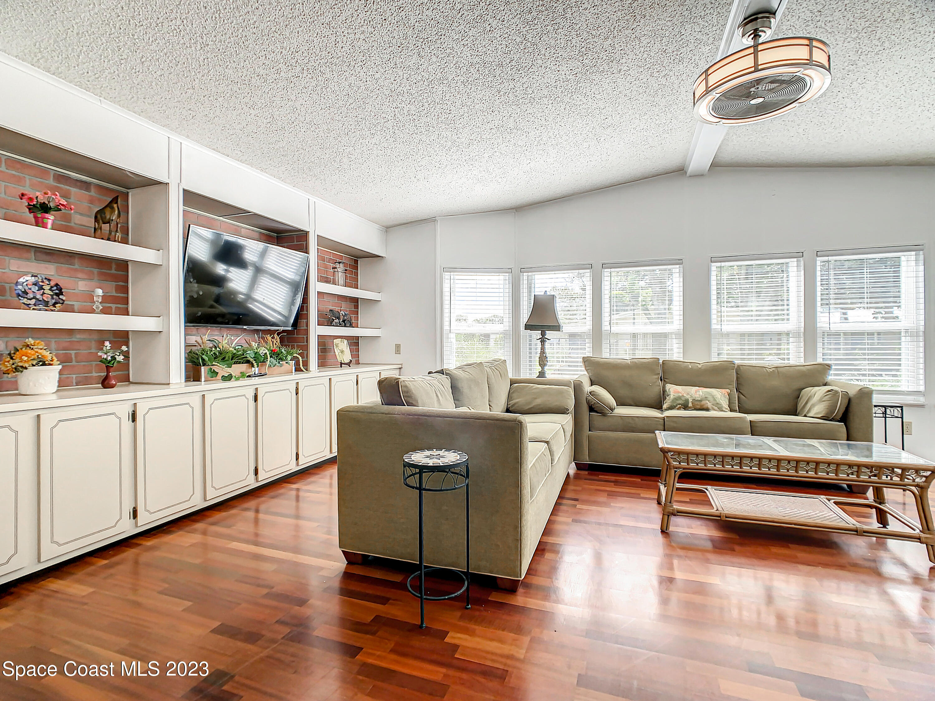 832 Periwinkle Circle Sebastian, FL 32976 - Photo 10 of 52 a living room with furniture and a wooden floor