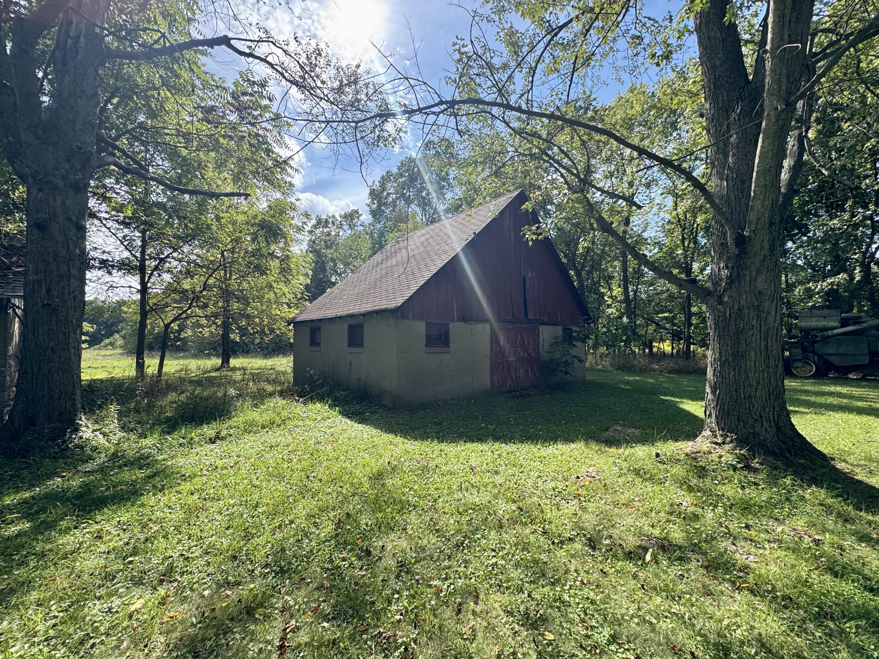 1038 Meridian Road Chesterton, IN 46304 - Photo 7 of 25 a view of backyard with large trees and wooden fence