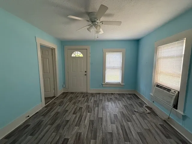wooden floor in an empty room with a window
