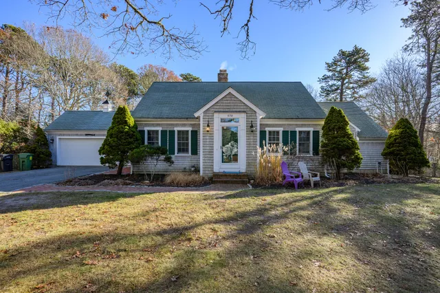 a view of a house with a patio and a yard