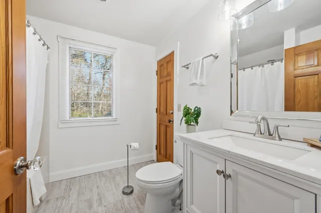 a bathroom with a sink toilet and a mirror