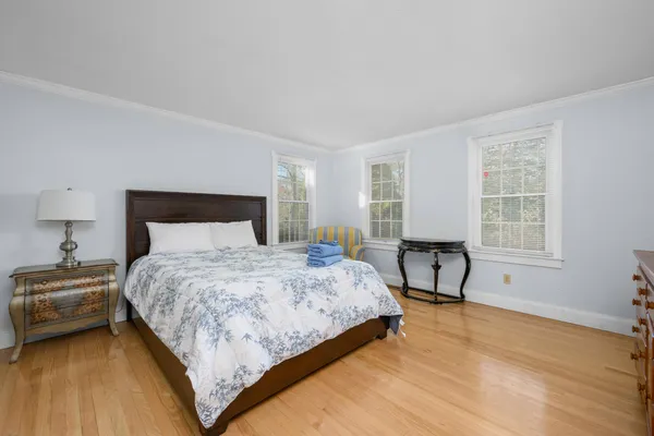 a bedroom with a bed chair and window