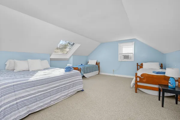 a bedroom with bed and a window