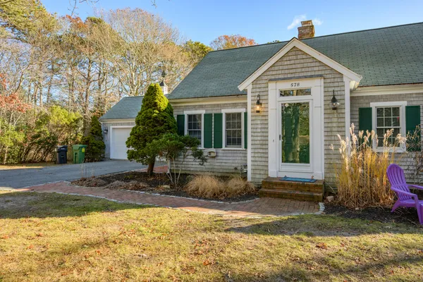 a front view of a house with garden