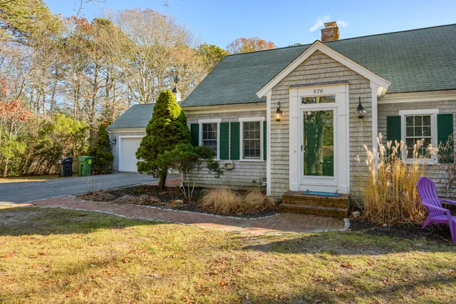 a front view of a house with garden
