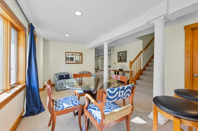 a dining room with furniture and wooden floor