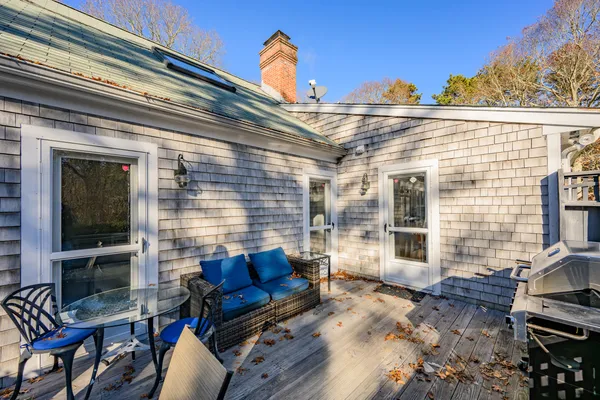 a view of a patio with chairs and potted plants