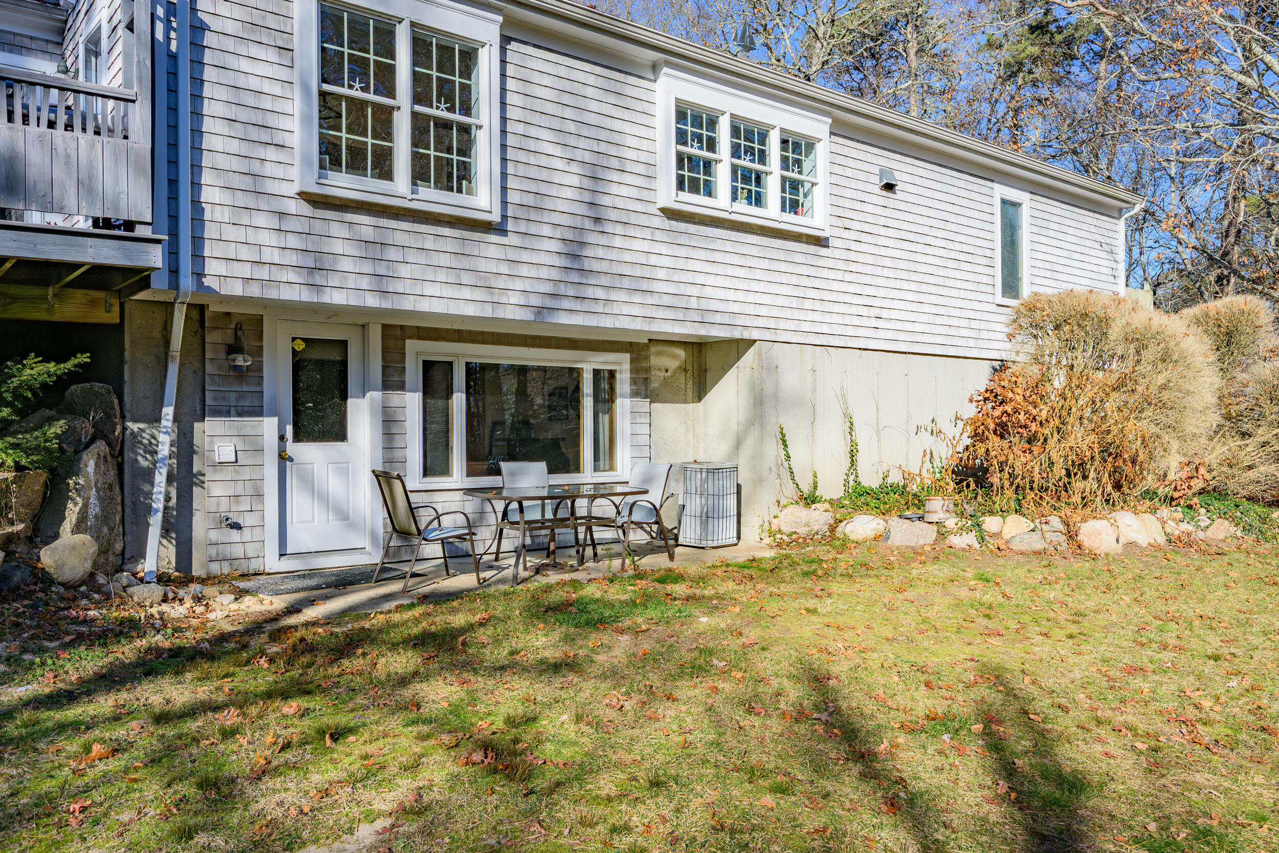 578 Huckins Neck Road Centerville, MA 02632 - Photo 39 of 42 a view of house with backyard outdoor seating and covered with trees