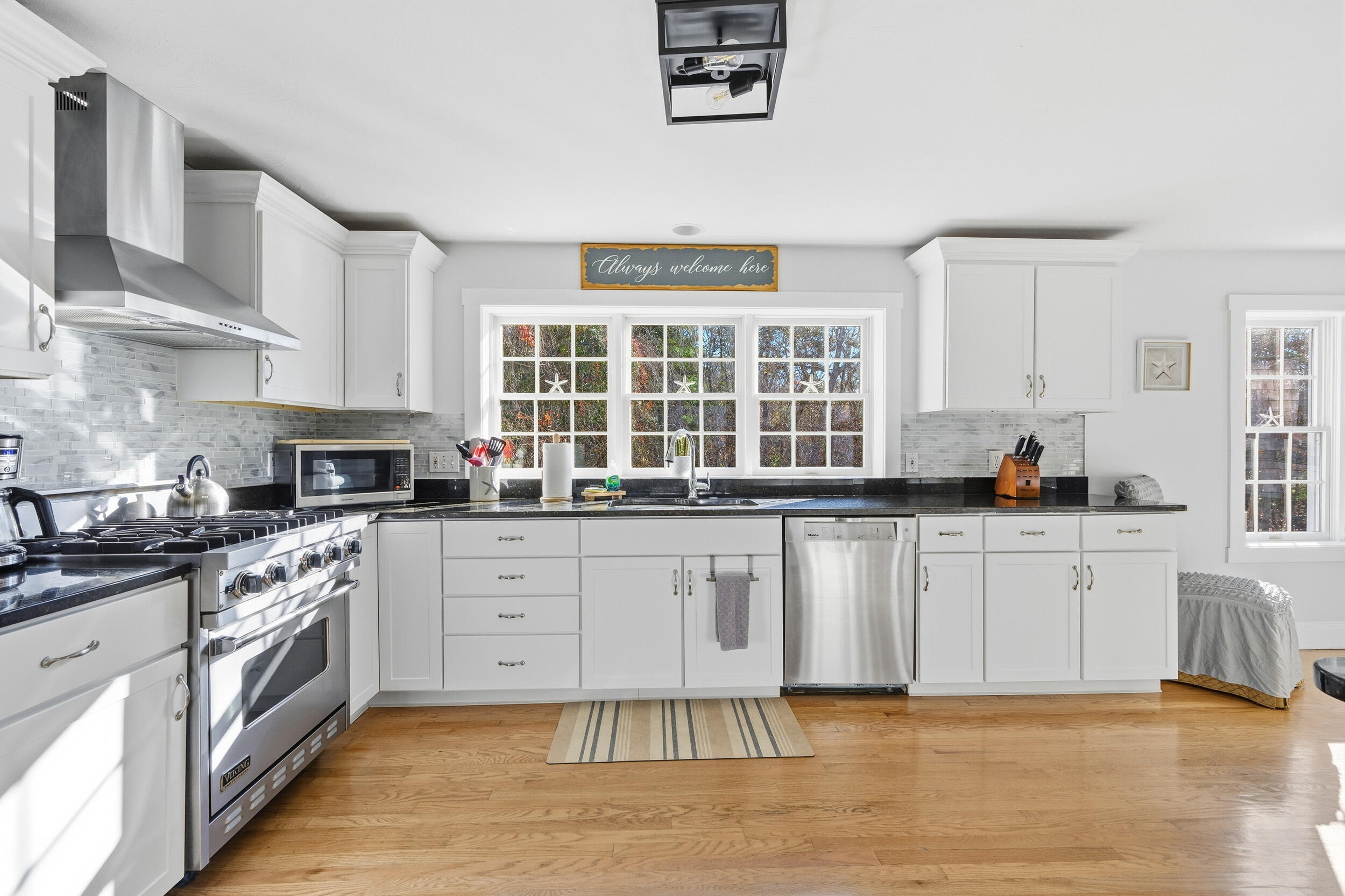 578 Huckins Neck Road Centerville, MA 02632 - Photo 5 of 42 a kitchen with stainless steel appliances granite countertop a stove a sink and a microwave