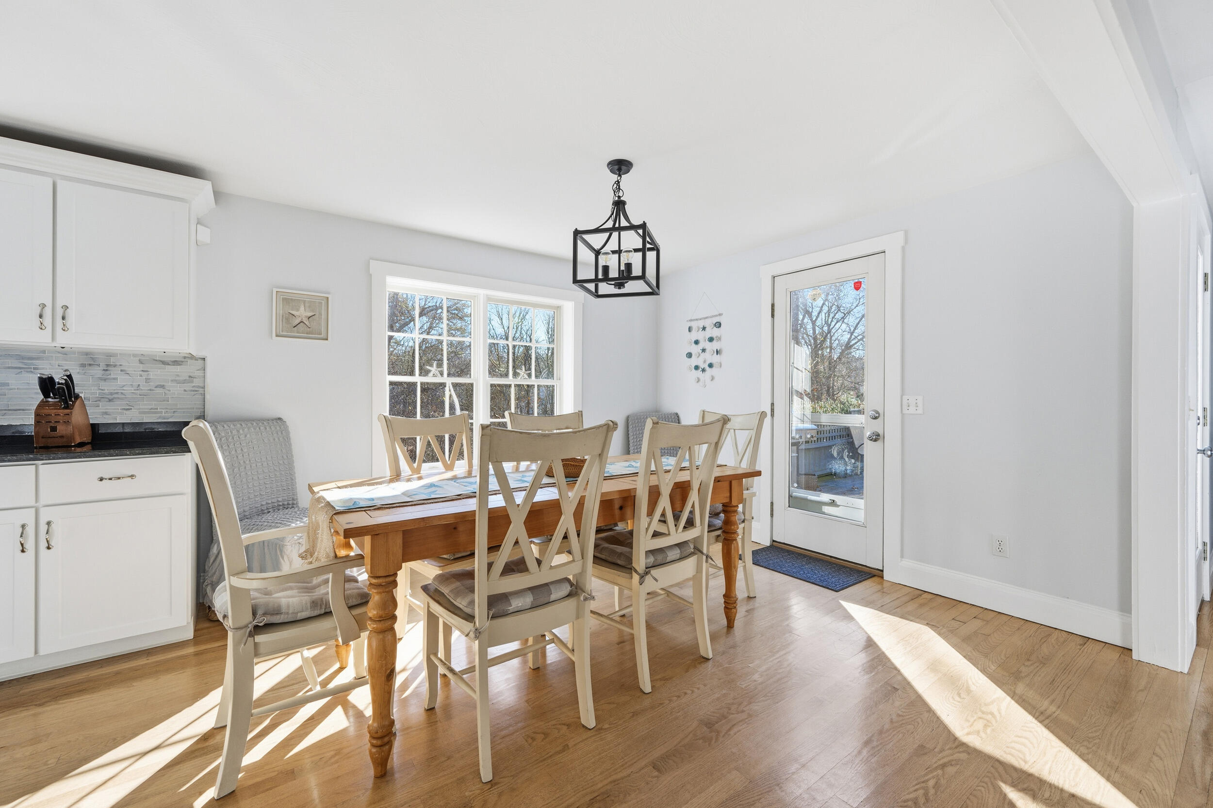 578 Huckins Neck Road Centerville, MA 02632 - Photo 10 of 42 a view of a dining room with furniture window and wooden floor