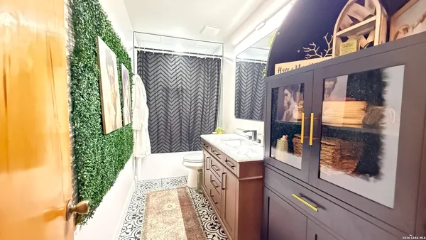 a bath room with a sink and a mirror