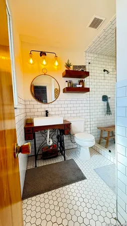 a bathroom with a sink toilet and mirror