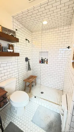 a white toilet sitting next to a bathroom sink