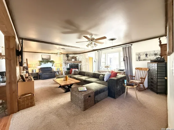a living room with furniture and a large window