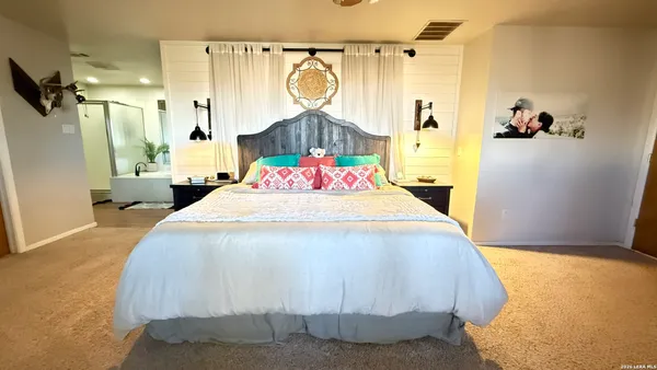 a bedroom with a bed and a mirror