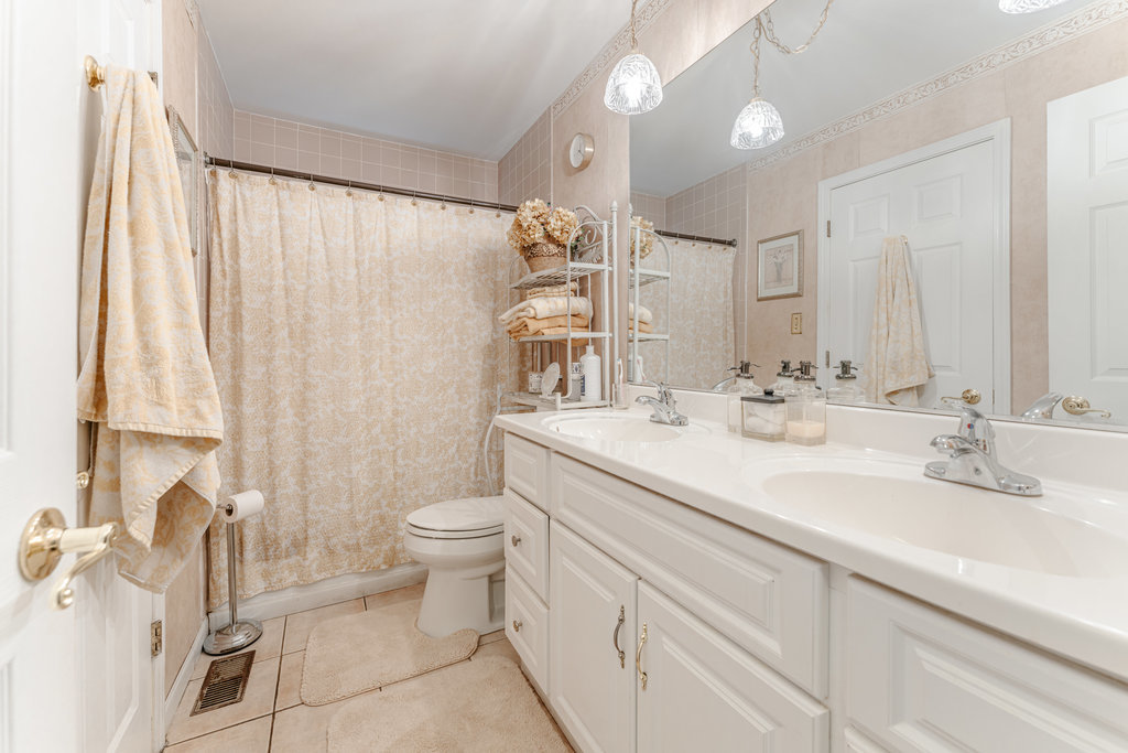 241 Huntingwood Road Matteson, IL 60443 - Photo 11 of 18 a bathroom with a double vanity sink toilet and a mirror
