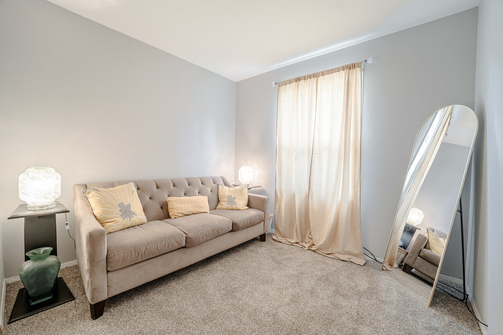 241 Huntingwood Road Matteson, IL 60443 - Photo 14 of 18 a living room with furniture a bed and a window