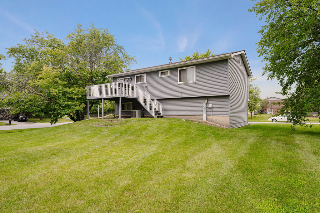 241 Huntingwood Road Matteson, IL 60443 - Photo 3 of 18 a front view of a house with a garden