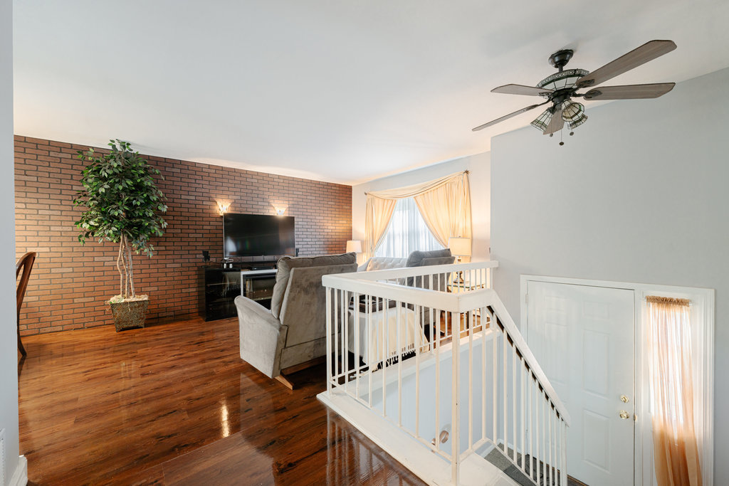 241 Huntingwood Road Matteson, IL 60443 - Photo 10 of 18 a view of a livingroom with wooden floor stairs and a way to couch