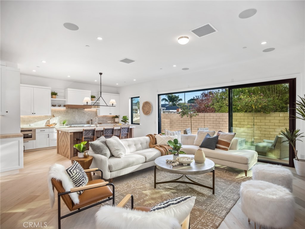 379 La Perle Place Costa Mesa, CA 92627 - Photo 1 of 8 a living room with furniture and a large window