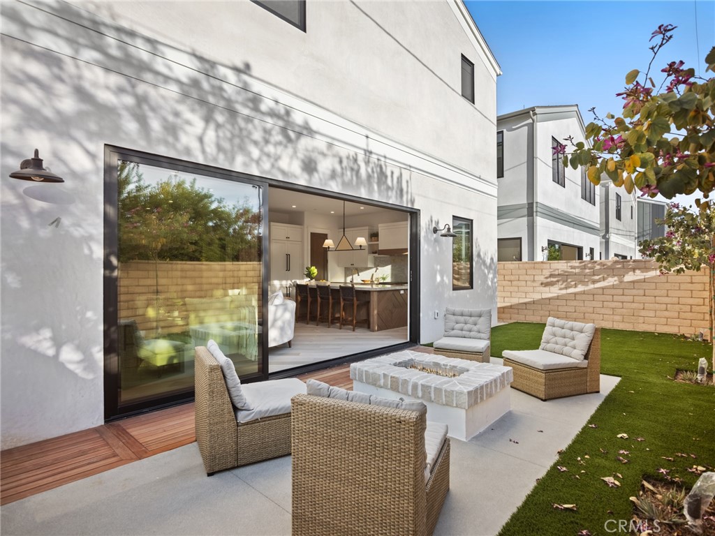 379 La Perle Place Costa Mesa, CA 92627 - Photo 7 of 8 a front view of a house with outdoor seating