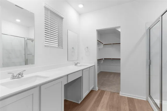 a bathroom with a double vanity sink and a mirror