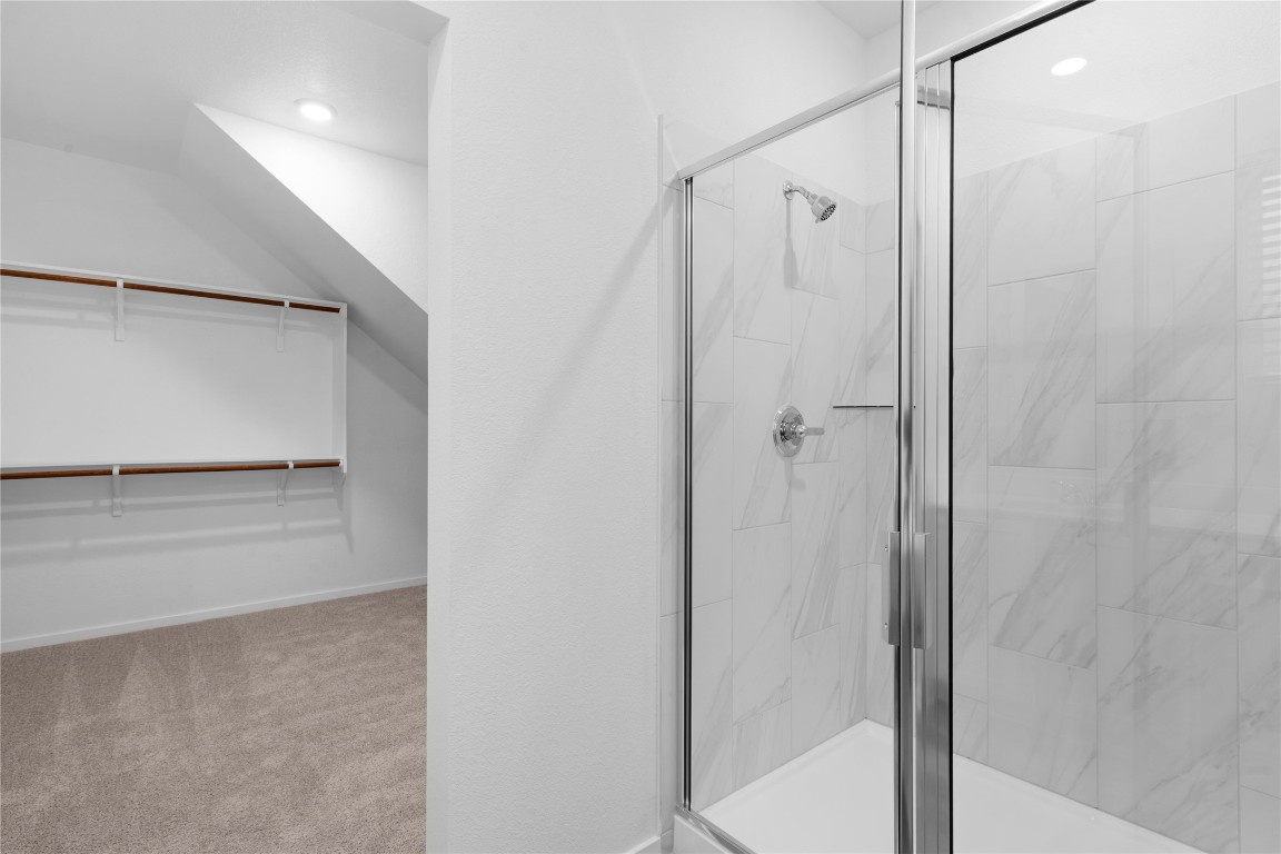 13725 Tucker Hedge Pass Elgin, TX 78621 - Photo 16 of 29 a bathroom with a shower and a glass door