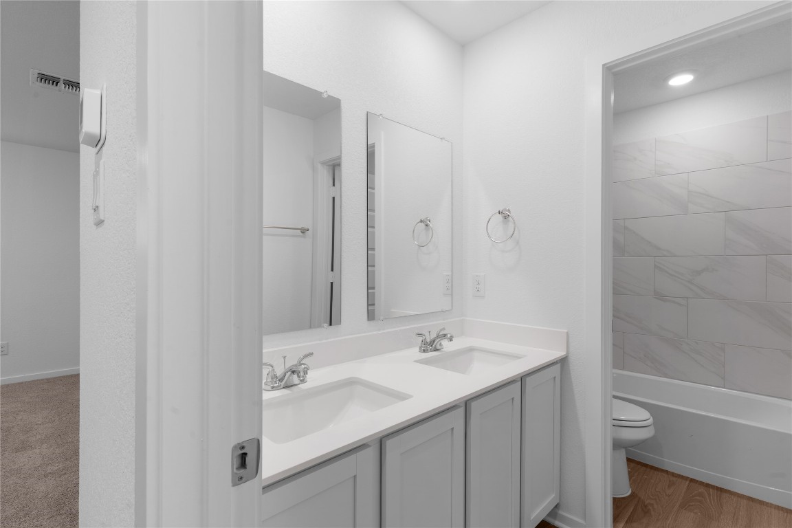 13725 Tucker Hedge Pass Elgin, TX 78621 - Photo 19 of 29 a bathroom with a sink toilet and shower