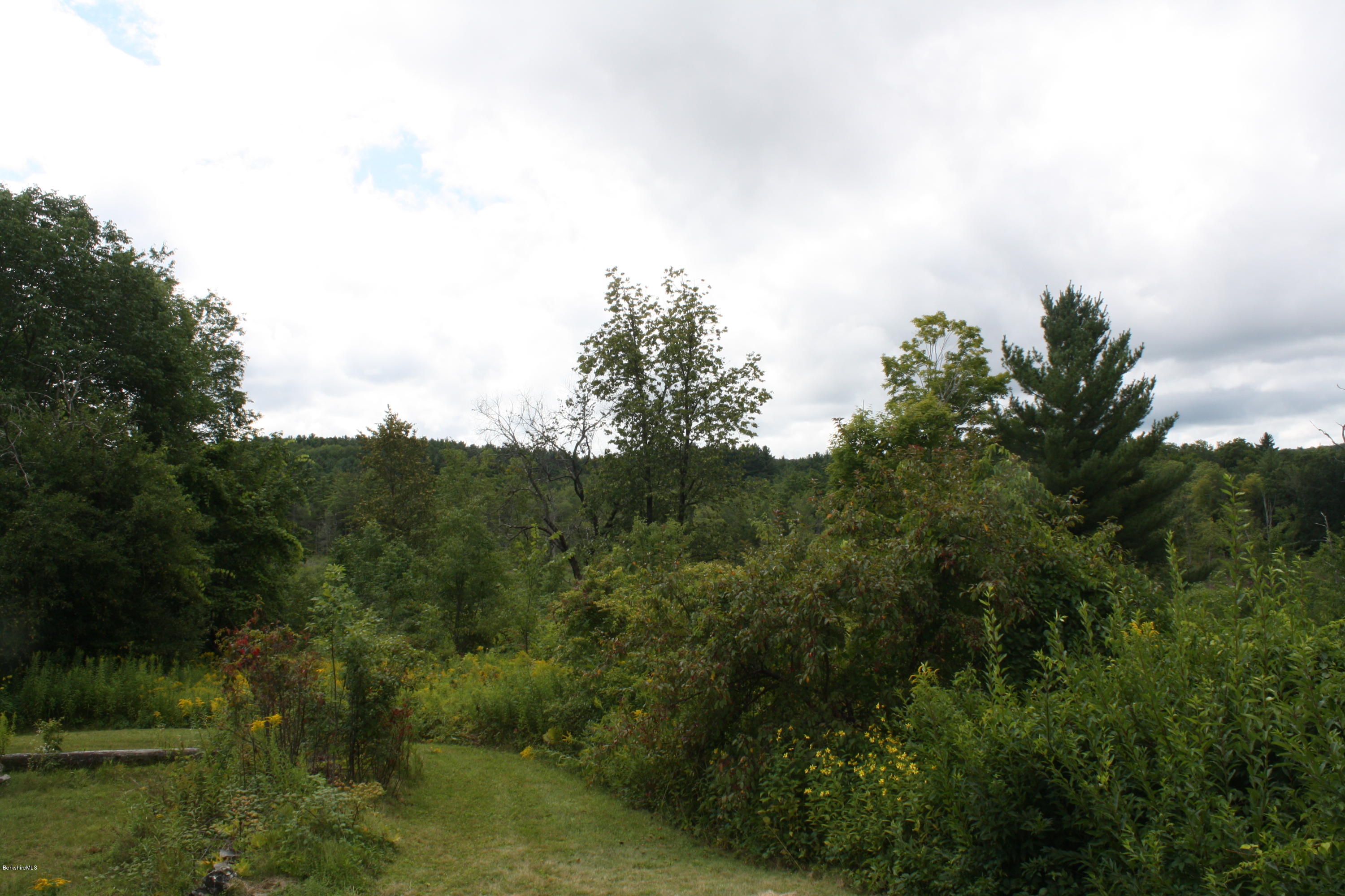 340 Main Road Monterey, MA 01245 - Photo 2 of 13 a view of a lake and green valley