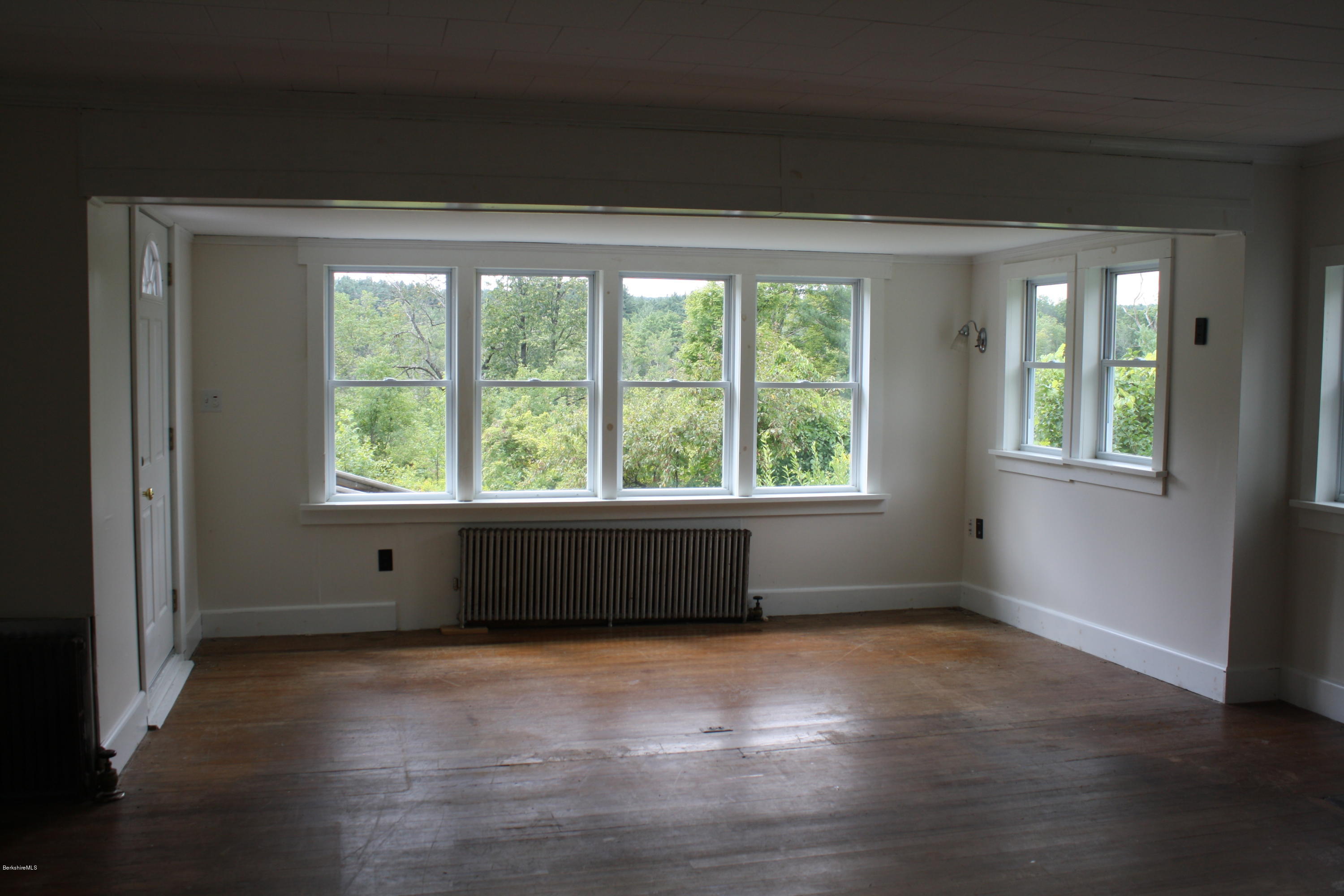 340 Main Road Monterey, MA 01245 - Photo 9 of 13 an empty room with wooden floor and windows