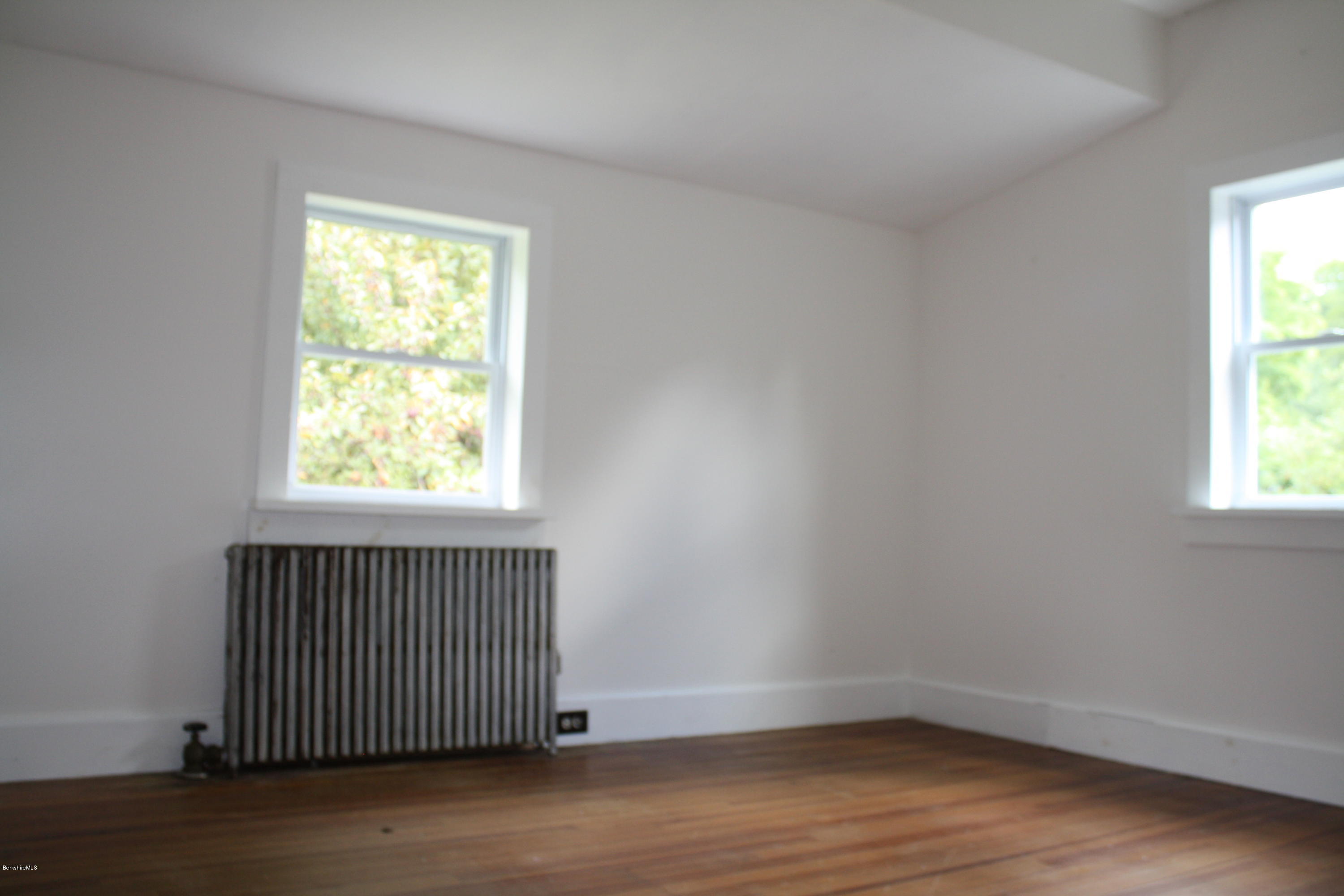 340 Main Road Monterey, MA 01245 - Photo 10 of 13 an empty room with wooden floor and windows