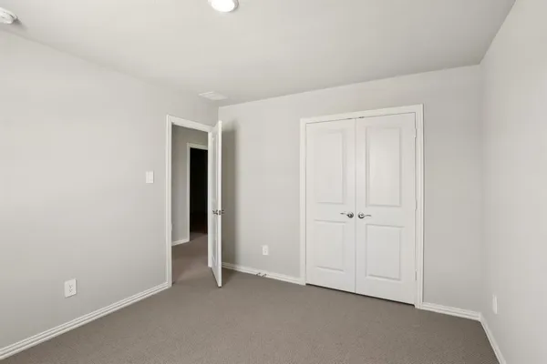 an empty room with closet area