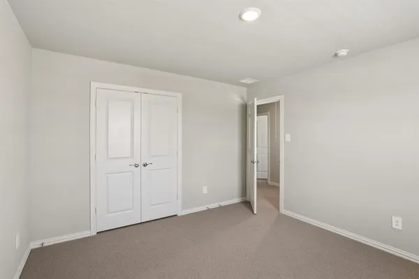 an empty room with closet area