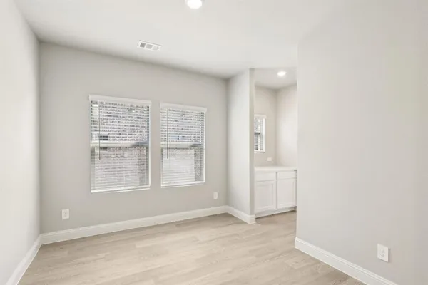 an empty room with windows and closet