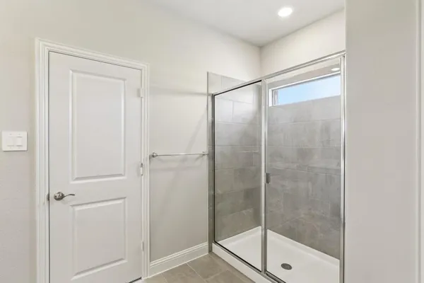 a bathroom with a glass shower door