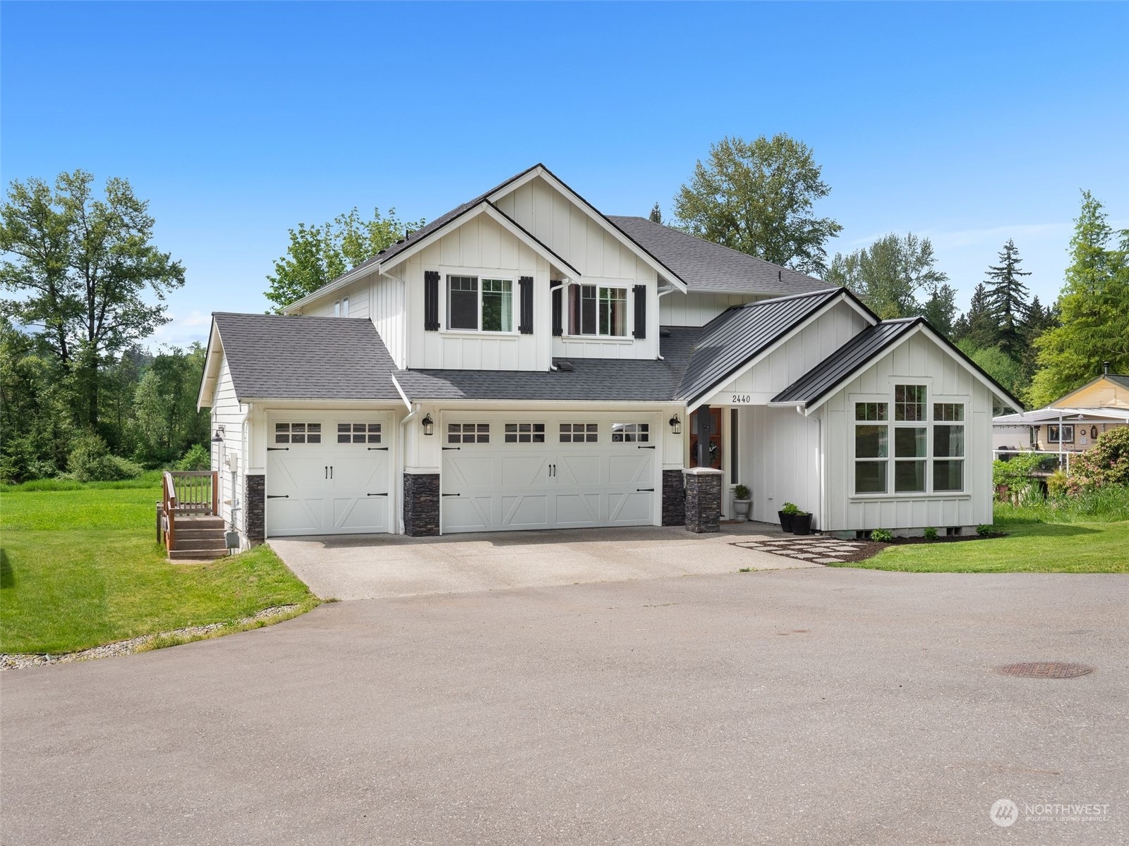 2440 Callow Road Lake Stevens, WA 98258 - Photo 27 of 34 a front view of a house with a yard and garage
