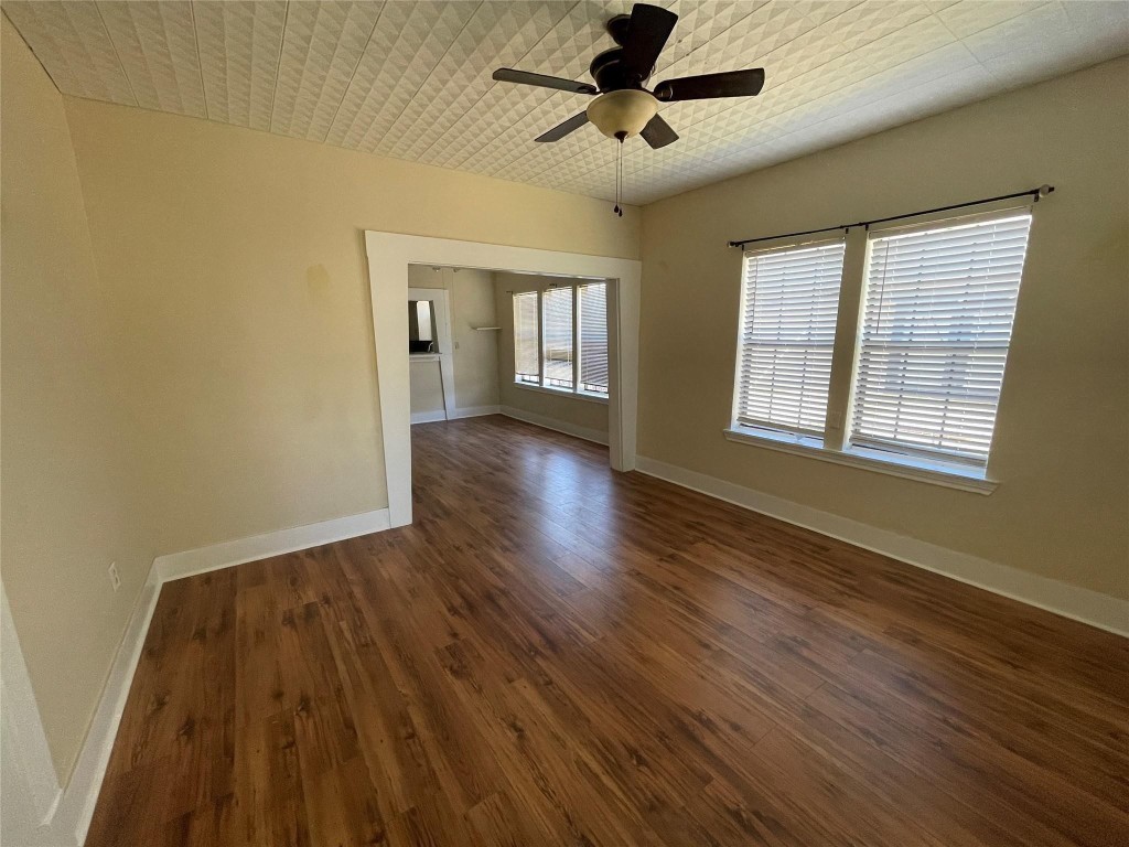3105 Indiana Street Baytown, TX 77520 - Photo 3 of 10 a view of an empty room with wooden floor and a window