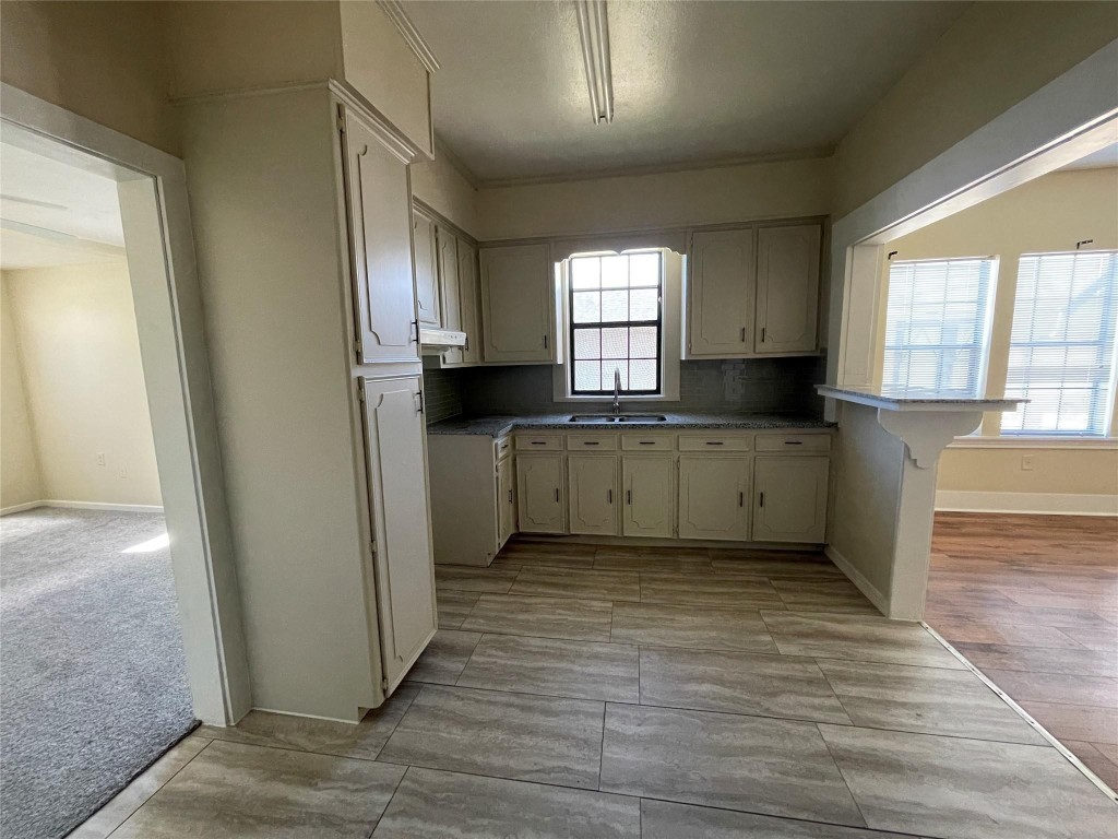 3105 Indiana Street Baytown, TX 77520 - Photo 5 of 10 a view of a kitchen with wooden floor and electronic appliances