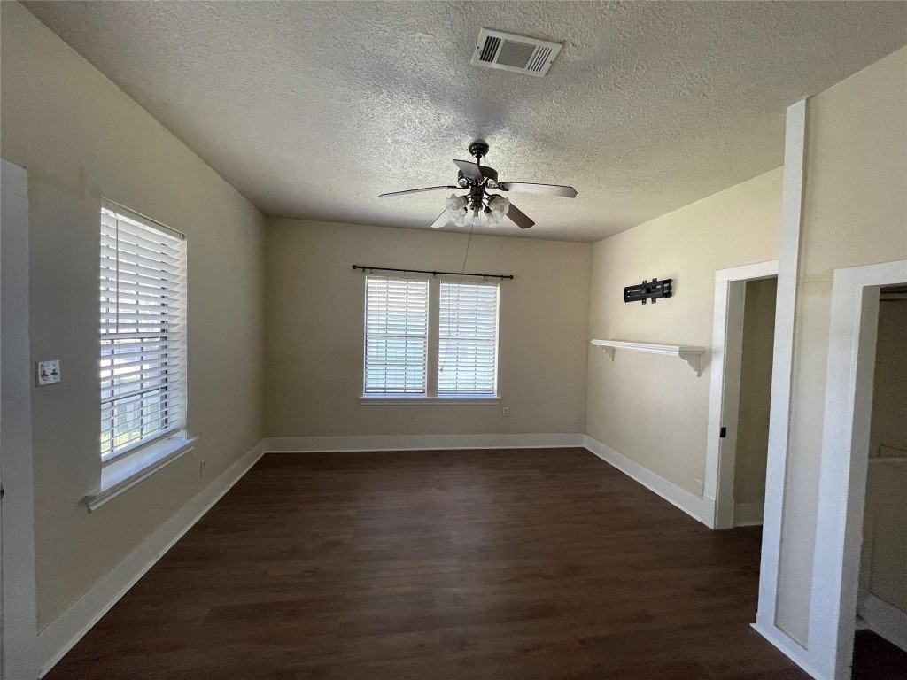 3105 Indiana Street Baytown, TX 77520 - Photo 6 of 10 a view of an empty room with wooden floor and a window