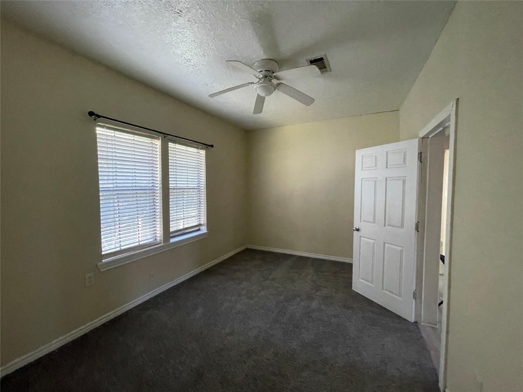 3105 Indiana Street Baytown, TX 77520 - Photo 8 of 10 an empty room with windows and fan