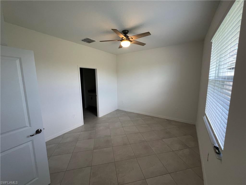 2320 Dragonfruit Way Naples, FL 34120 - Photo 16 of 33 Tiled spare room with visible vents, ceiling fan, and baseboards