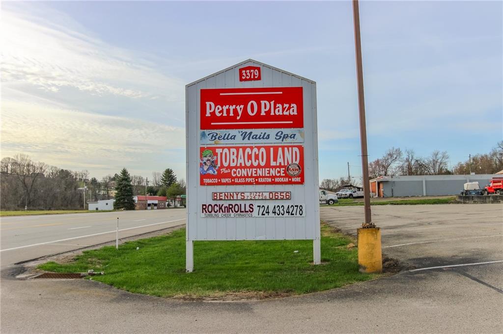 3379 Pittsburgh Street, Unit 109 Perryopolis, PA 15473 - Photo 2 of 47 a sign on the side of the road