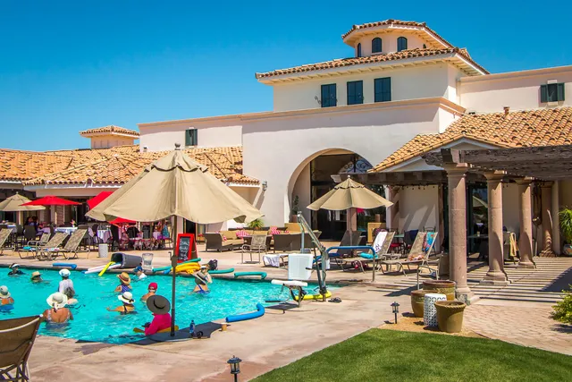 a patio with a table and chairs under an umbrella