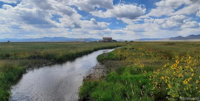 a view of a lake with green space