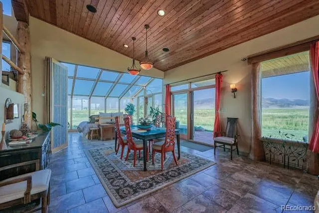 a view of a patio with table and chairs potted plants with wooden floor