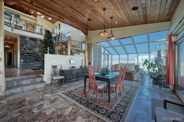 a dining room with furniture window and wooden floor